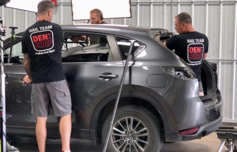 dent shop hail team working on vehicle