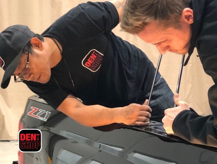 two men working on paintless dent repair