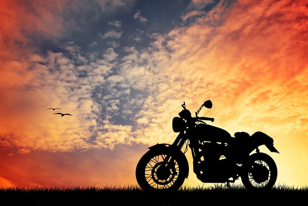 motorcycle next to a sunset